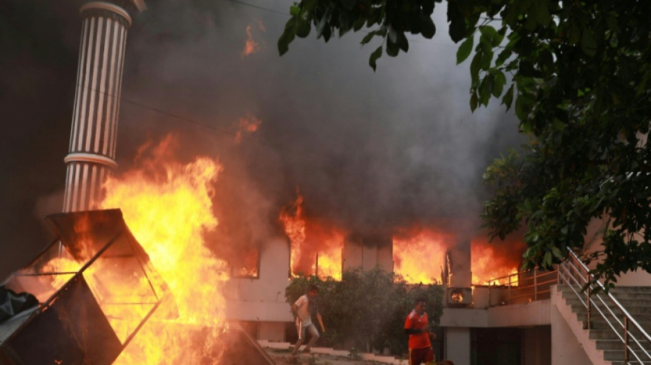Nepal protesters set parliament ablaze as PM quits