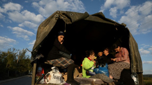 Karabakh refugees burn cherished possessions on way out